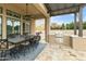 Spacious covered patio with outdoor kitchen and dining area, perfect for entertaining and enjoying al fresco meals at 3314 E Kael St, Mesa, AZ 85213