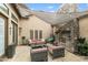 Charming outdoor patio with stone fireplace, comfortable seating, and stylish decor for relaxation and entertainment at 3314 E Kael St, Mesa, AZ 85213