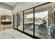 Expansive glass doors offer seamless indoor-outdoor living, revealing a luxurious patio and pool area at 3314 E Kael St, Mesa, AZ 85213