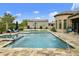 A stunning pool with spa, water features, and travertine tile surround create an outdoor oasis for relaxation and entertainment at 3314 E Kael St, Mesa, AZ 85213