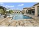 Beautiful backyard pool with water features, basketball court, and covered seating area at 3314 E Kael St, Mesa, AZ 85213