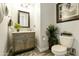 Stylish powder room with elegant vanity, framed elephant print, and decorative greenery at 3314 E Kael St, Mesa, AZ 85213