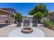Inviting backyard area with a cozy fire pit, comfortable seating, and mature landscaping at 3397 E Derringer Way, Gilbert, AZ 85297