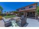 Inviting backyard with a covered patio, fire pit, and lush green lawn at 3397 E Derringer Way, Gilbert, AZ 85297