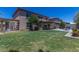 Spacious backyard with covered patio, lush lawn, and outdoor seating areas for relaxation at 3397 E Derringer Way, Gilbert, AZ 85297