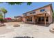 Expansive backyard featuring a covered patio, brick fire pit, and desert landscaping, perfect for outdoor entertaining at 3397 E Derringer Way, Gilbert, AZ 85297