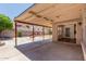 Covered backyard patio featuring a concrete slab, a brick fire pit, and access to an indoor area at 3397 E Derringer Way, Gilbert, AZ 85297