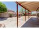 Large covered patio with a fire pit, surrounded by trees and greenery, creating a cozy outdoor space at 3397 E Derringer Way, Gilbert, AZ 85297