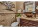 Charming powder room showcasing unique fixtures, decorative mirror, and beautiful tile work at 3397 E Derringer Way, Gilbert, AZ 85297