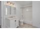 Bright bathroom featuring a vanity with a marble countertop, mirrored cabinet, and a shower-tub combo at 3397 E Derringer Way, Gilbert, AZ 85297