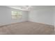 Bedroom with neutral carpet, ceiling fan, and two windows offering pleasant views and natural light at 3397 E Derringer Way, Gilbert, AZ 85297