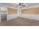 Bedroom featuring a ceiling fan and a view into a closet with shelving at 3397 E Derringer Way, Gilbert, AZ 85297
