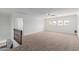 Large bedroom featuring carpeted floors, neutral walls, a ceiling fan and large windows with neighborhood views at 3397 E Derringer Way, Gilbert, AZ 85297
