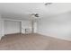 Spacious carpeted bedroom features neutral walls, a ceiling fan, and staircase access at 3397 E Derringer Way, Gilbert, AZ 85297