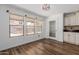 Cozy dining area with wood floors, large windows offering plenty of natural light, and kitchen access at 3397 E Derringer Way, Gilbert, AZ 85297