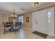Dining area with chandelier, decorative furniture, and tile flooring near the home's entryway at 3397 E Derringer Way, Gilbert, AZ 85297