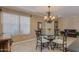 Dining area with table, chairs, and chandelier near large window at 3397 E Derringer Way, Gilbert, AZ 85297