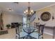 Dining area with a chandelier, glass table, and decorative chairs near staircase at 3397 E Derringer Way, Gilbert, AZ 85297