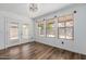 Bright dining area with wood floors, backyard views through large windows and glass paneled door at 3397 E Derringer Way, Gilbert, AZ 85297