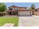 Inviting two-story home featuring a two-car garage, well-manicured lawn, and a charming covered porch at 3397 E Derringer Way, Gilbert, AZ 85297