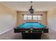 Large game room featuring a well-maintained pool table and a decorative light fixture, ideal for entertaining at 3397 E Derringer Way, Gilbert, AZ 85297