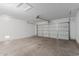 Wide garage with finished walls, visible garage door mechanism, and plenty of open space at 3397 E Derringer Way, Gilbert, AZ 85297