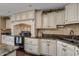Spacious kitchen with granite countertops, stainless steel appliances, and dark wood flooring at 3397 E Derringer Way, Gilbert, AZ 85297