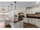 Updated kitchen featuring an island with a granite countertop, modern appliances, and ample cabinet space at 3397 E Derringer Way, Gilbert, AZ 85297