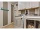 Well-equipped laundry room featuring a modern washer and dryer with updated cabinets at 3397 E Derringer Way, Gilbert, AZ 85297