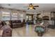 Open concept living room with tile flooring and seamless transition to kitchen and dining areas at 3397 E Derringer Way, Gilbert, AZ 85297