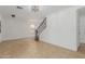 Open-concept living room with tile flooring, a staircase, and neutral paint at 3397 E Derringer Way, Gilbert, AZ 85297