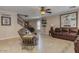 Living room with tile flooring, comfortable seating, and staircase at 3397 E Derringer Way, Gilbert, AZ 85297