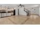 Large living room featuring tile flooring, stairs to upper level, and entrance to front door at 3397 E Derringer Way, Gilbert, AZ 85297