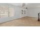 Open-concept living room featuring tile flooring, large windows, and white walls at 3397 E Derringer Way, Gilbert, AZ 85297