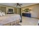 Spacious main bedroom with a ceiling fan and neutral colored tile flooring at 3397 E Derringer Way, Gilbert, AZ 85297