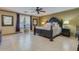 Spacious main bedroom with a ceiling fan and neutral colored tile flooring at 3397 E Derringer Way, Gilbert, AZ 85297