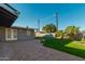 Spacious backyard features artificial turf, mature landscaping and stone paver patio at 346 E Highland Ave, Phoenix, AZ 85012