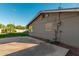 Large concrete patio overlooks the backyard with mature landscaping and turf at 346 E Highland Ave, Phoenix, AZ 85012