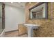Bathroom with a unique stone surround around the vanity and large mirror at 346 E Highland Ave, Phoenix, AZ 85012