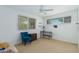 Bright bedroom featuring a ceiling fan, desk, chair and lots of light from large windows at 346 E Highland Ave, Phoenix, AZ 85012