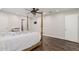 Cozy bedroom with hardwood floors, ceiling fan, and TV mounted on the wall at 346 E Highland Ave, Phoenix, AZ 85012