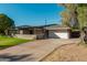 Single-story home with a wide driveway, two-car garage, and covered porch perfect for outdoor living at 346 E Highland Ave, Phoenix, AZ 85012
