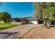 Single-story home with a wide driveway, two-car garage, and covered porch perfect for outdoor living at 346 E Highland Ave, Phoenix, AZ 85012