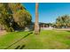 Well-maintained home with a lush front lawn and mature landscaping, offering shade and curb appeal at 346 E Highland Ave, Phoenix, AZ 85012