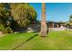 Well-maintained home with a lush front lawn and mature landscaping, offering shade and curb appeal at 346 E Highland Ave, Phoenix, AZ 85012