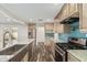 Modern kitchen with stainless steel appliances, marble countertops, and a blue backsplash at 346 E Highland Ave, Phoenix, AZ 85012