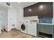 A spacious laundry room with ample storage and a utility sink at 346 E Highland Ave, Phoenix, AZ 85012