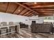 Spacious living room featuring a wood beamed ceiling, fireplace, and hardwood floors at 346 E Highland Ave, Phoenix, AZ 85012