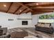 Inviting living room with fireplace, bright window, and hardwood floors at 346 E Highland Ave, Phoenix, AZ 85012