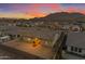 Sunset aerial view of the home showcases its location with desert mountain views and surrounding neighborhood at 3502 E Hazeltine Way, Queen Creek, AZ 85142